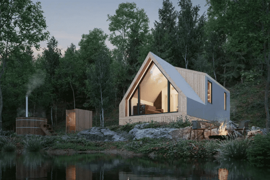 light grayish white a frame shaped park model tiny home in woods of VT