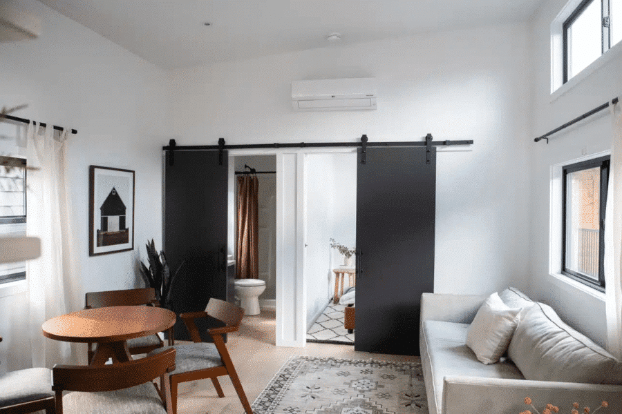 living room inside park model tiny home with separate rooms for bedroom and bathroom