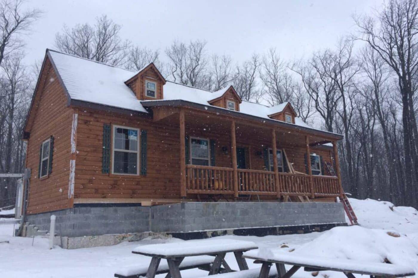 Winterized Log Cabin in the falling snow