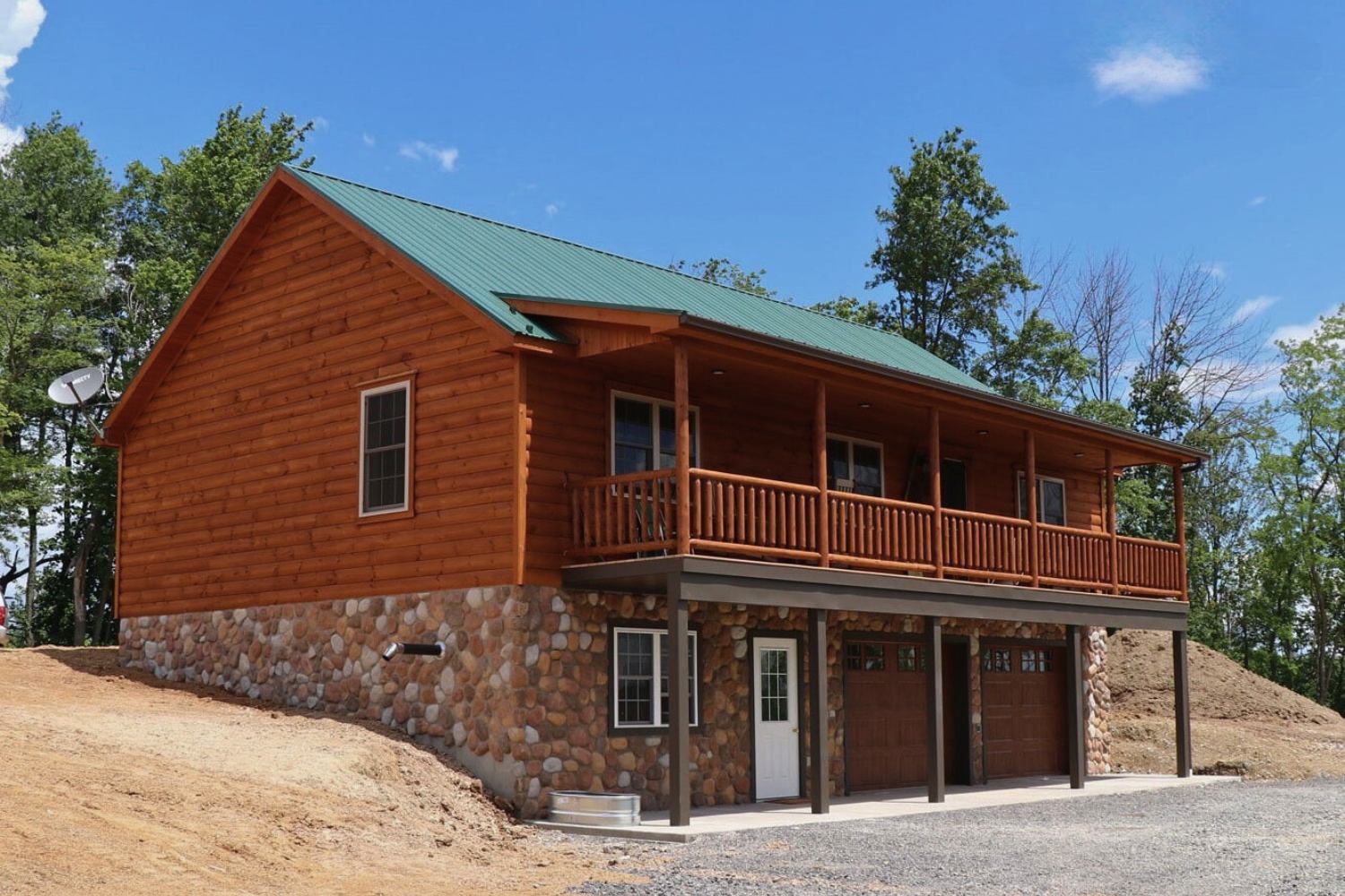 Log Cabin placed on full basement foundation with view of basement and garage doors