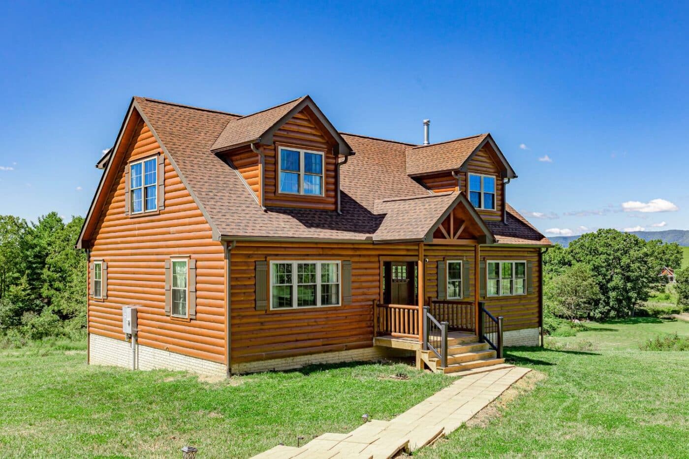 Log Cabin with path in grass on sunny day