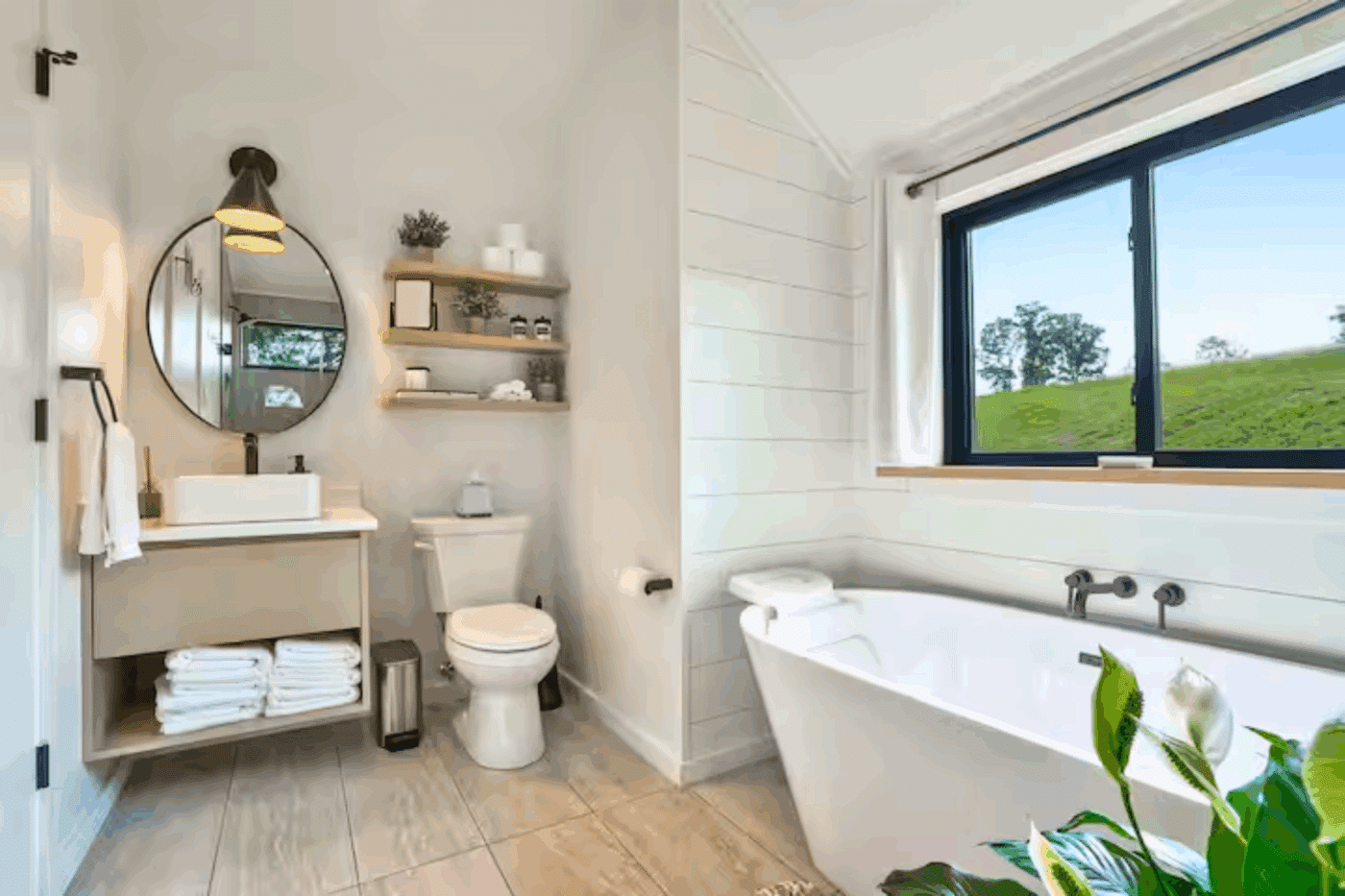 Soaking tub toilet and vanity area of A frame park model tiny home