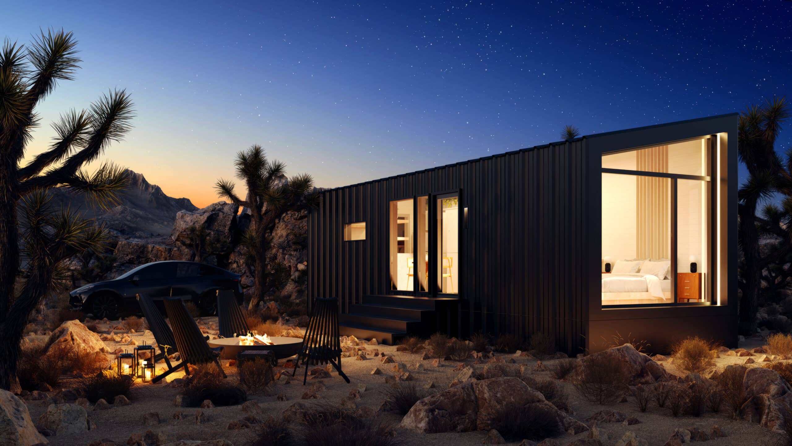 Modern desert tiny home with sleek black exterior, large windows, outdoor seating area, and fire pit under a starry night sky surrounded by desert vegetation