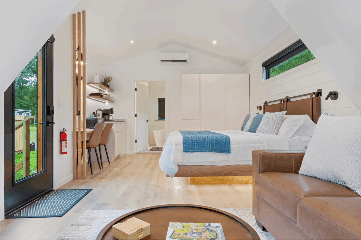 Bedroom and kitchenette area of A frame Studio with large closet Rushing Water 2 in pond eddy New York at The Outpost Resort