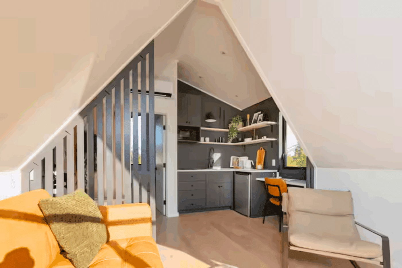 A frame park model tiny home living room and kitchen area built and designed by Psy Homes in Gap Pa unit located in Durango Co