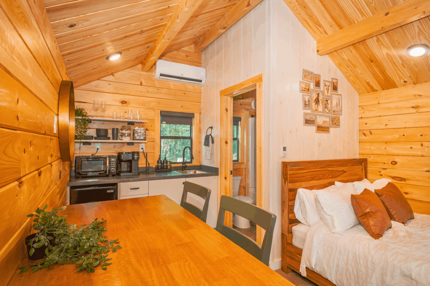 kitchen and dining area of log studio park model tiny home at The Outpost in Pond Edd New york cabin 3