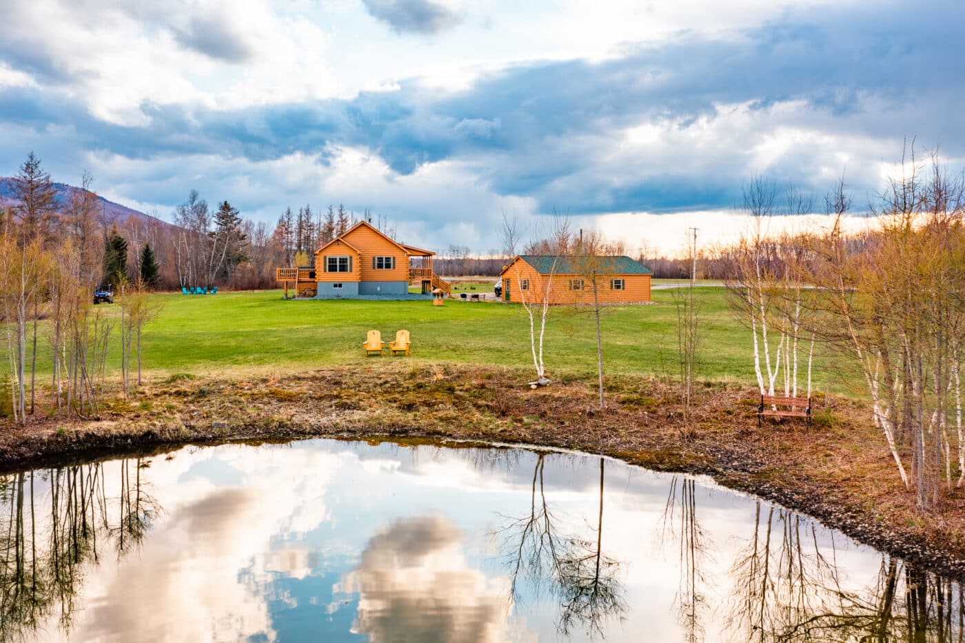 pond view of musketeer log cabin in jefferson nh