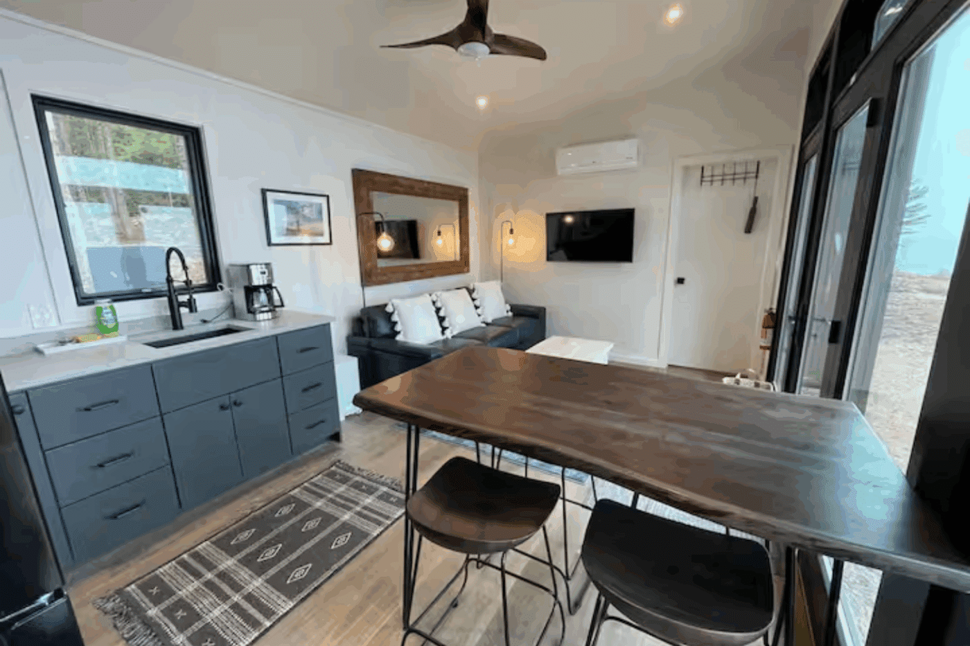 Alpine park model tiny home Newberry Michigan dining and living room area with mini split for heating and cooling