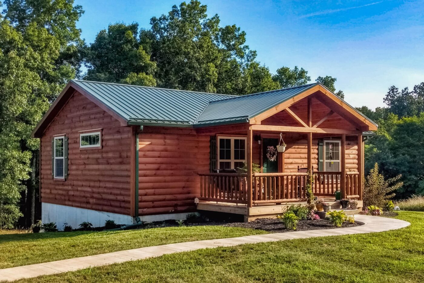 Pioneer log cabin with elevated deck and multiple windows in Tennessee.