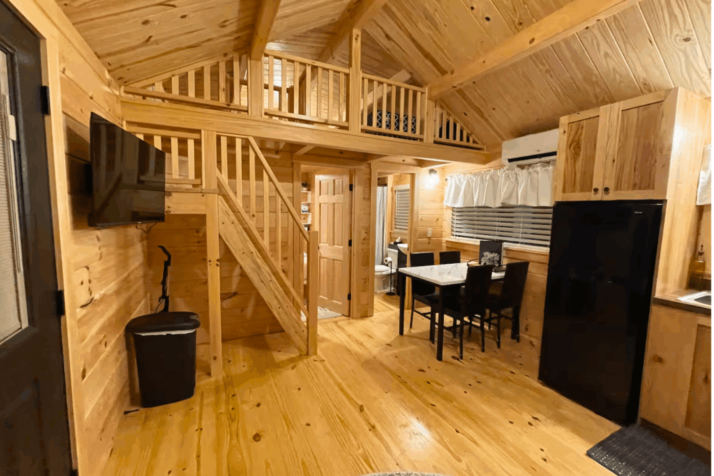 Dining Area in Pinecrest park model tiny home featuring lofted sleeping area secondary bedroom and full sized bathroom