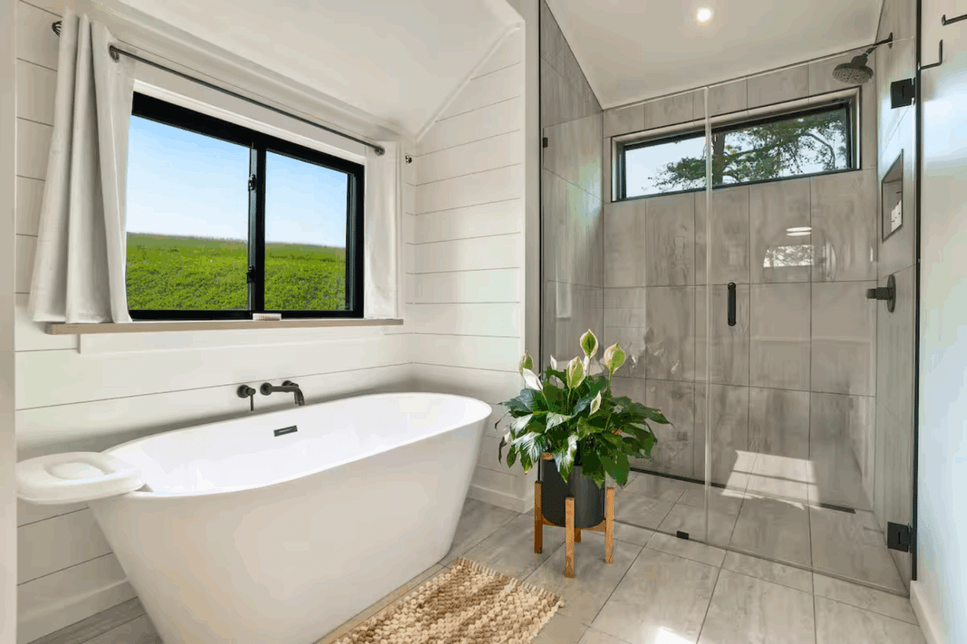 Soaking tub and walk in shower area of A frame studio park model tiny home in Augusta West Virginia