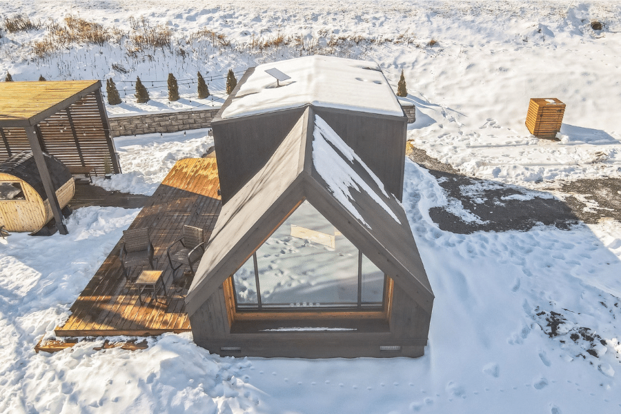 aerial view of gray a frame ADU in snow