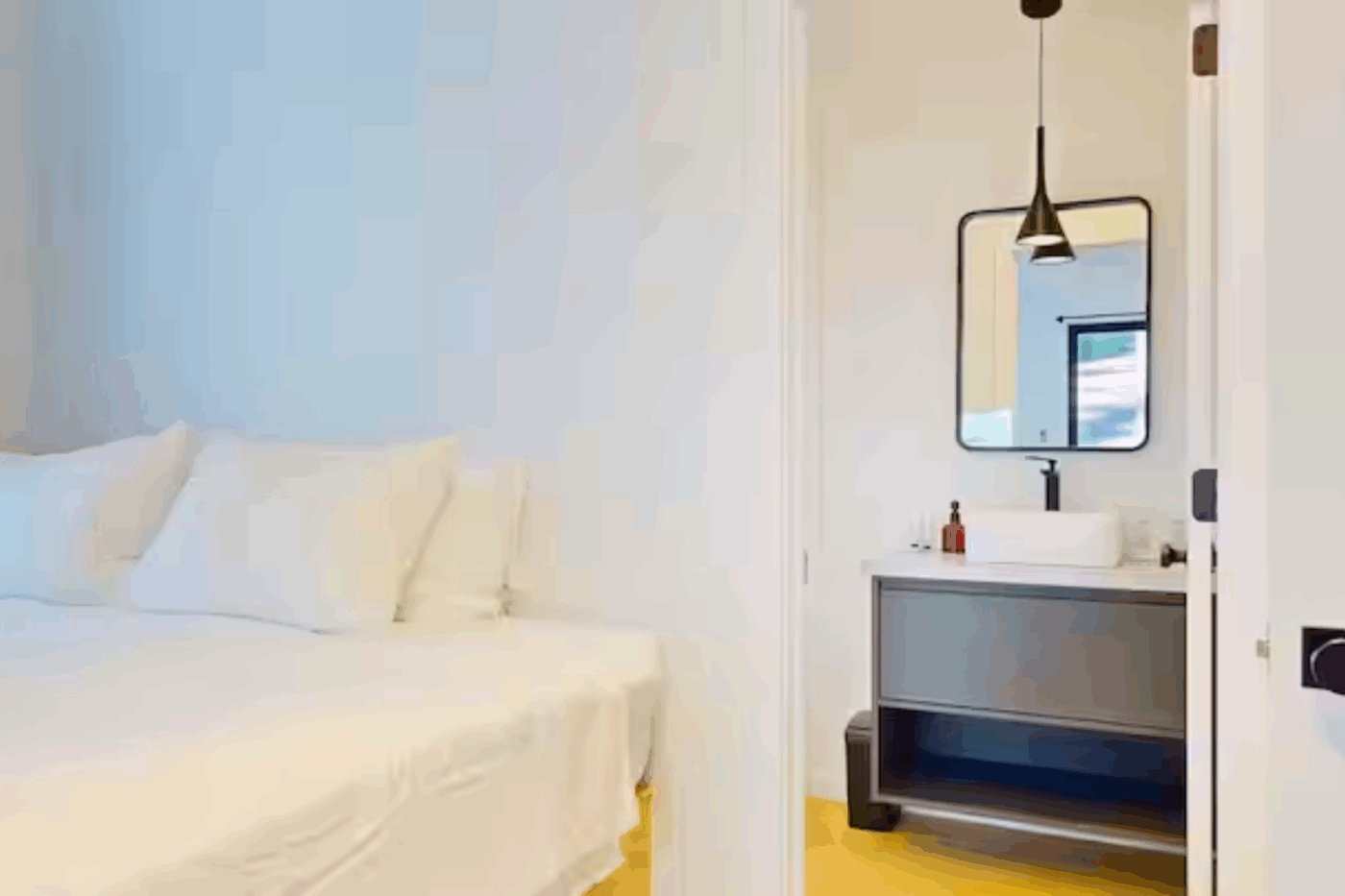 Cozy bedroom with private bathroom in A frame park model tiny home built and designed by Psy Homes in Wiscasset Maine