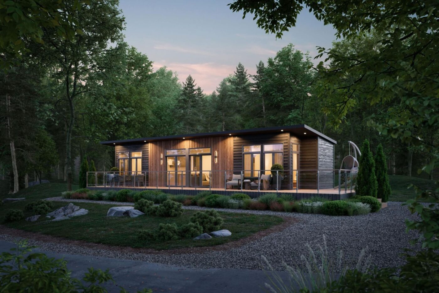 Sonoma ADU cabin with large glass doors and exterior lighting, nestled in a wooded clearing at twilight.