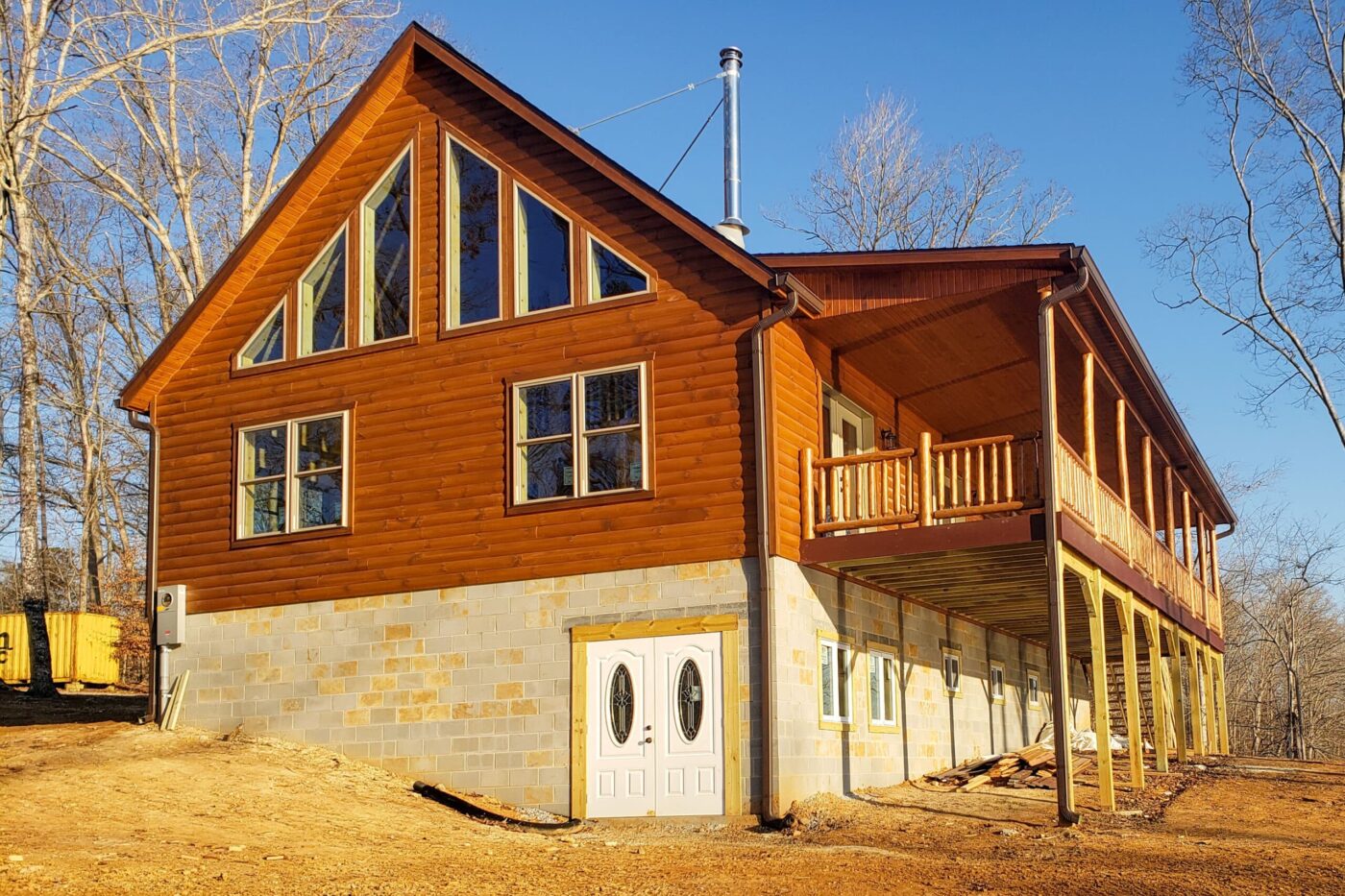 Timberline log cabin with front porch and wooded surroundings in New York.