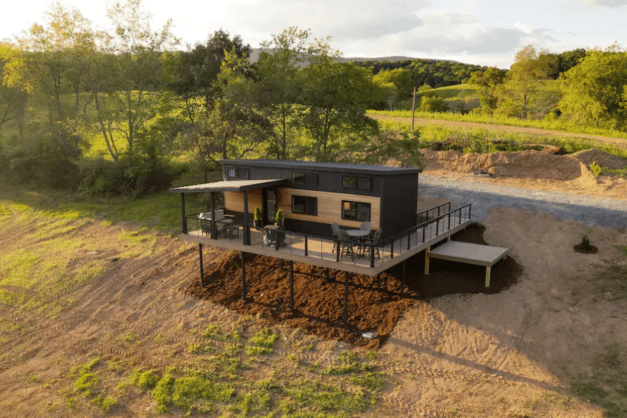 park model tiny home on porch overlooking field
