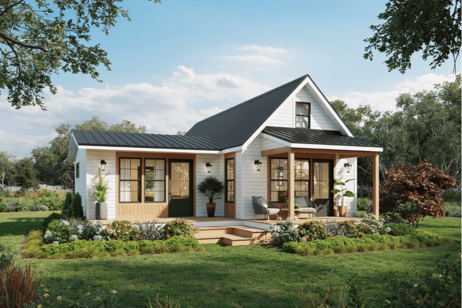 Grove ADU with white siding and black metal roofing with front porch in clearing