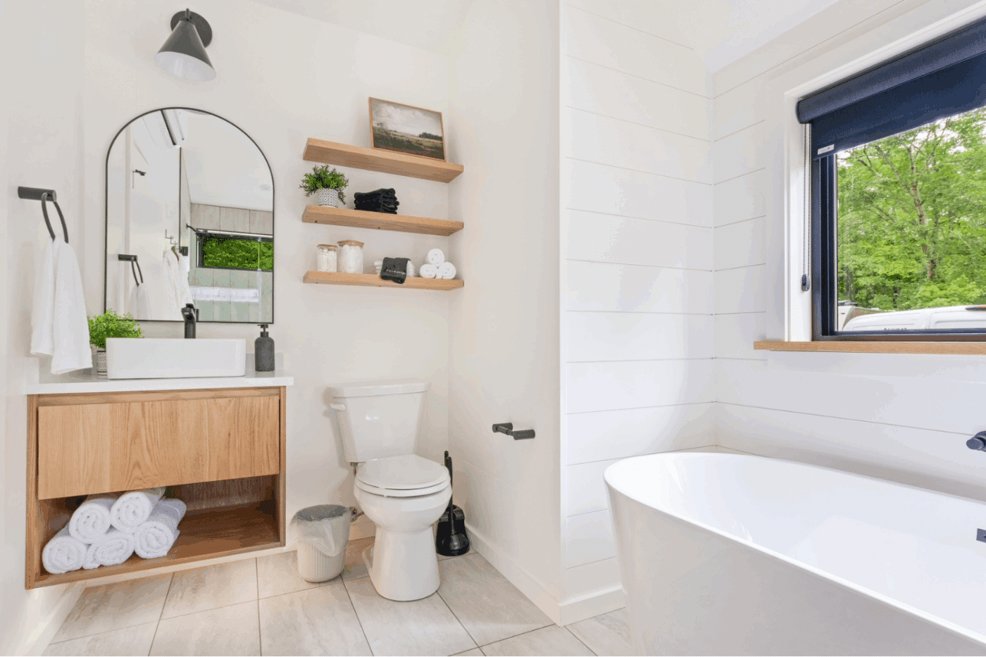 Rushing water 2 A frame studio park model tiny home luxury bathroom with large soaking tub at The Outpost Resort