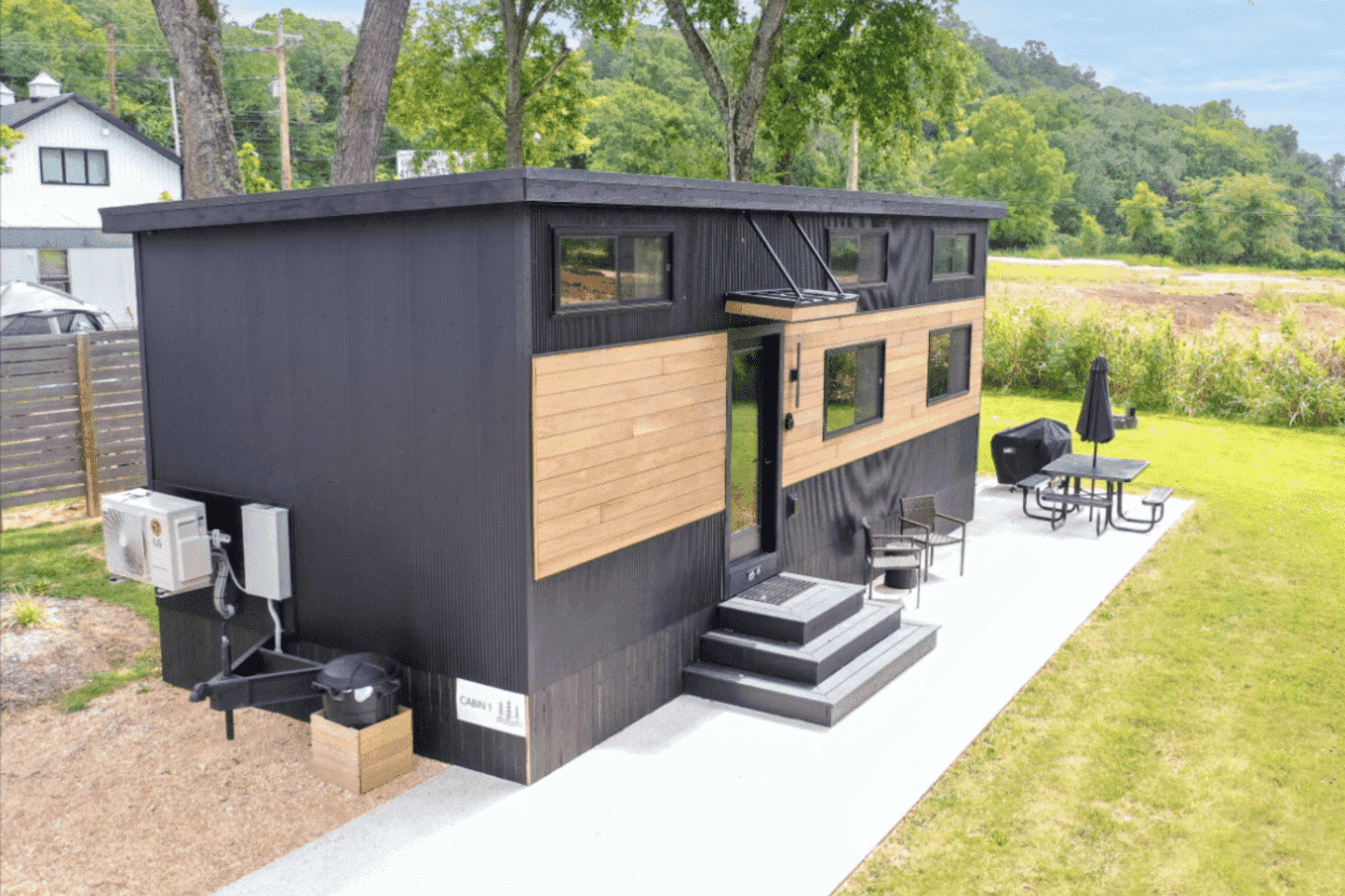 Modern Cascade park model tiny home with sleek black siding and expansive windows in Michigan.