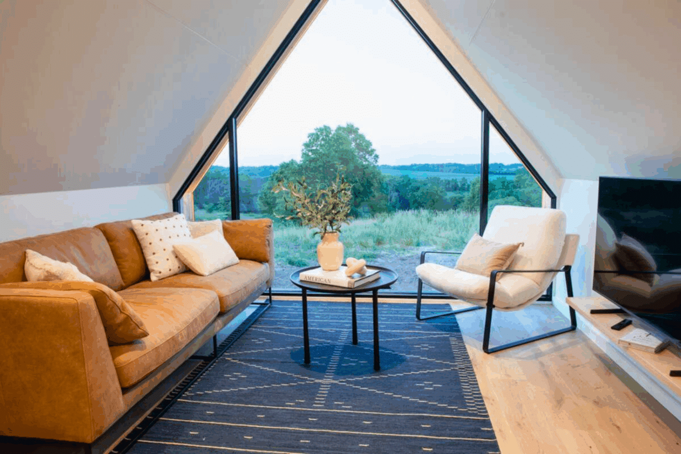 living room of A frame park model tiny home in Memphis MO built and designed by Zook cabins in Gap PA
