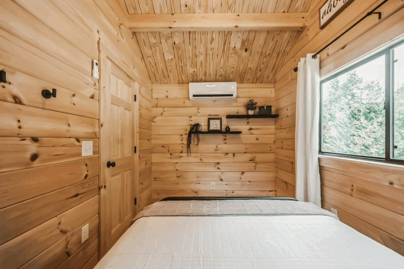 Primary bedroom with mini split for climate control built and designed by Zook cabins located in Strasburg Pa