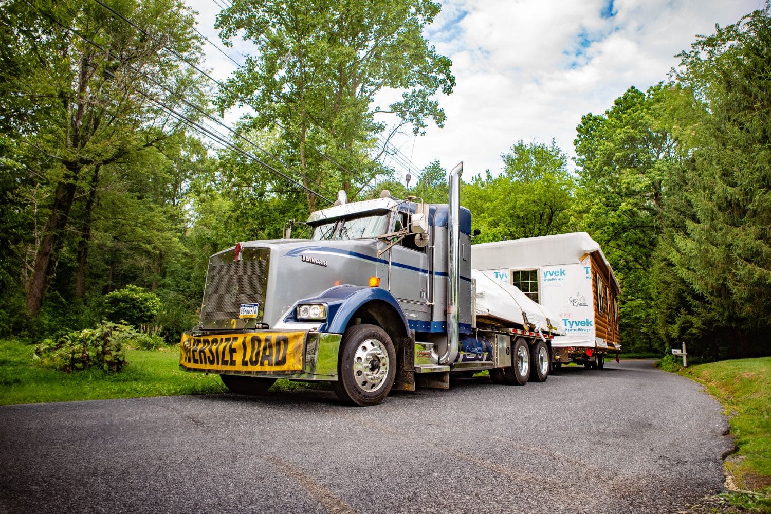 Cabin delivered on truck with oversize load sign
