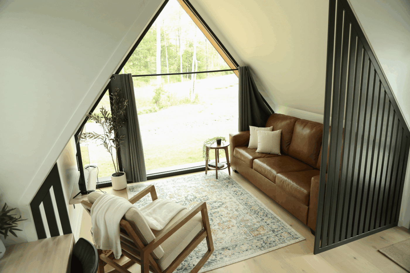 living room of A Frame 27 park model tiny home at HArtment Center in Milroy Pa