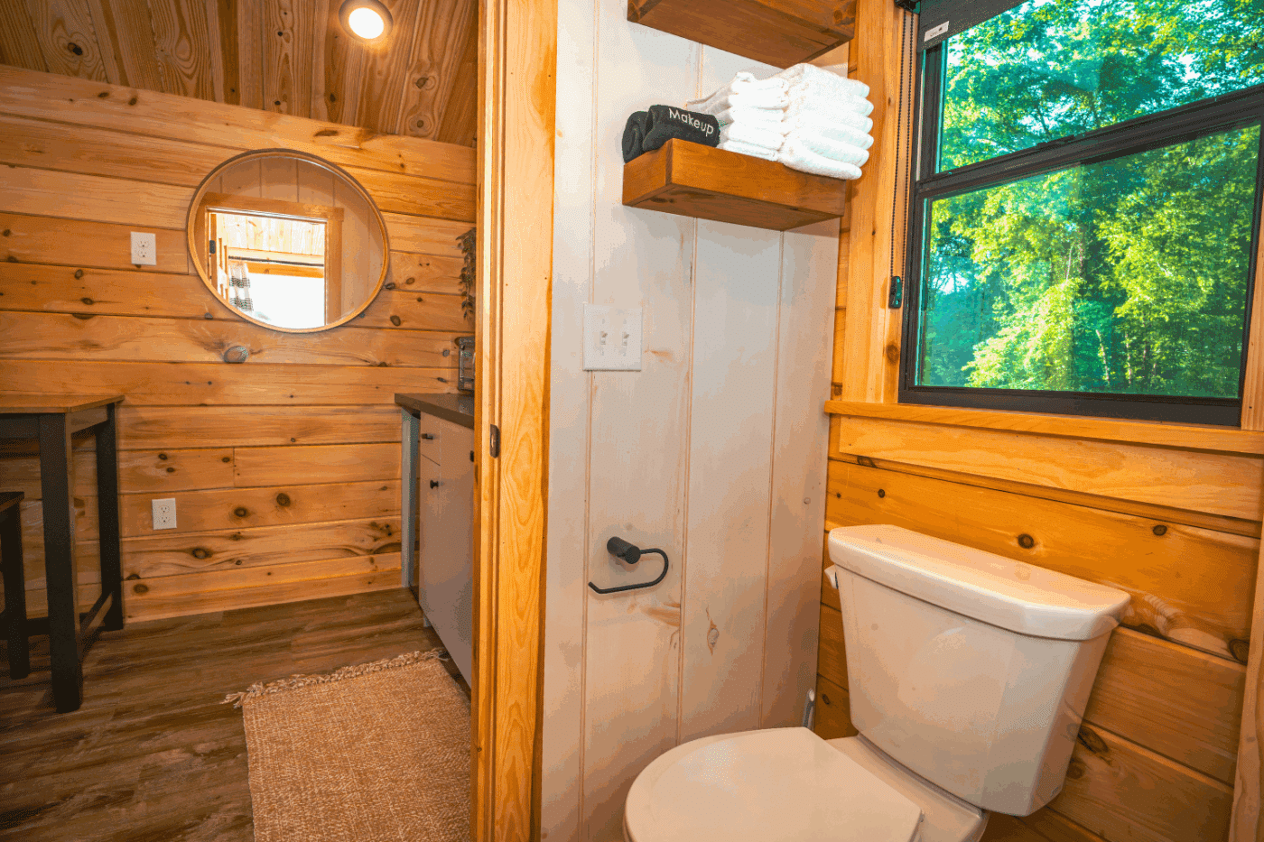 Bathroom of log studio park model tiny home in pond eddy new york at the outpost resort cabin 3