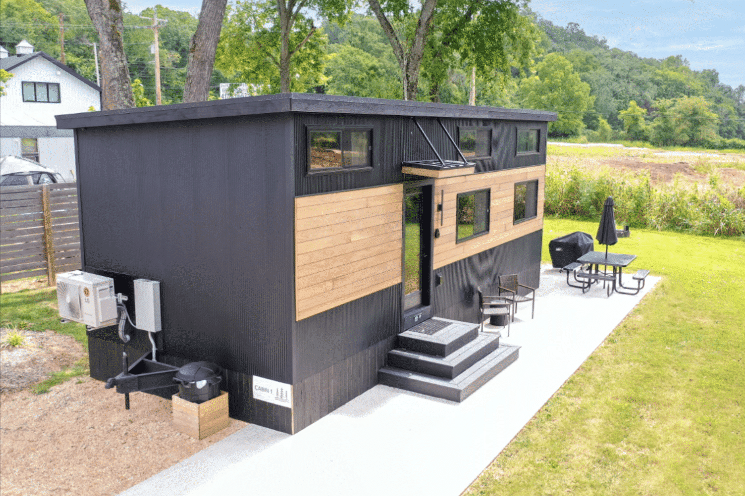 Modern Cascade park model tiny home with sleek black siding and expansive windows in Michigan.