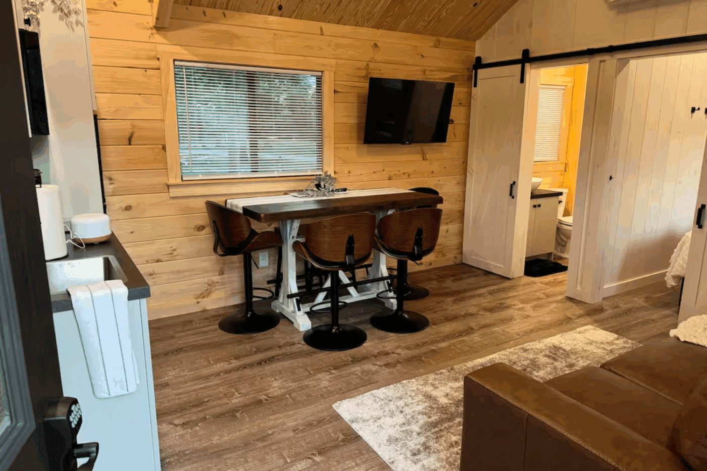 Livingroom kitchen and dining room of Pinecrest park model tiny home in New holland pa at Red Run Resort site 66