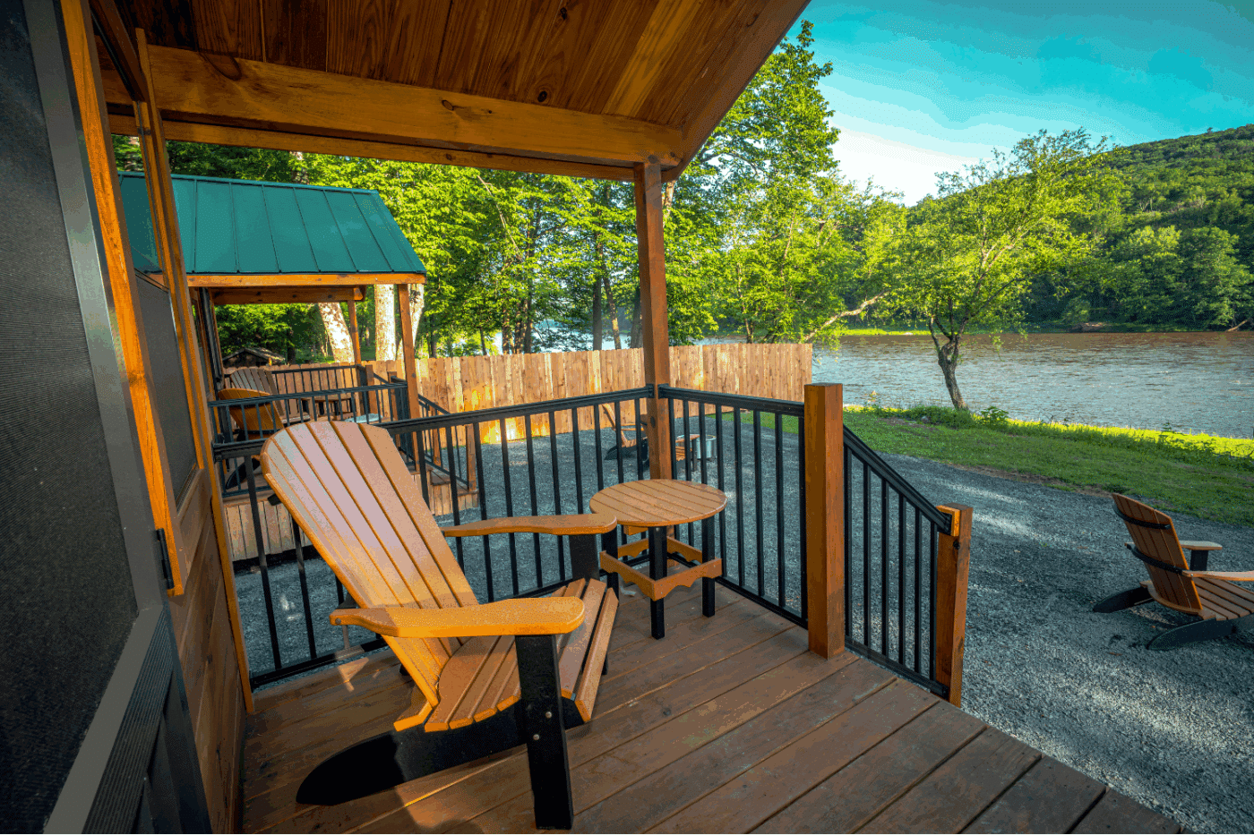 front porch of log studio park model tiny home in Pond Eddy New York at The Outpost cabin 2