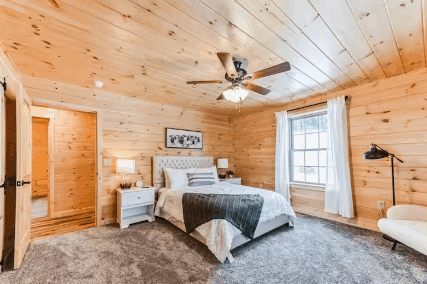 Master Bedroom of Mountaineer Deluxe in Sarnac Lake New York with carpeted floors