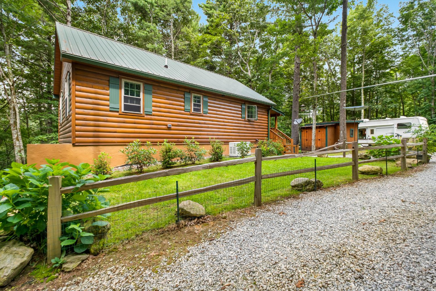 External Log Cabin Construction Details with view of outside of cabin and side garden and yard
